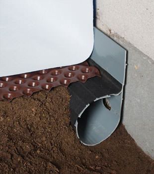 Closeup of a crawl space drainage system installed in Benicia