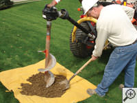 Auguring a hole in the earth for a foundation repair in Rancho Cordova