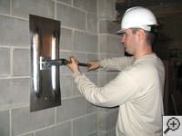 Attempting to straighten a bowed foundation wall by straightening a wall anchor system in a Vacaville home.