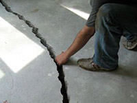 a severely damaged cracked concrete slab floor in Novato