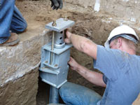 Foundation repair contractors installing the foundation bracket in Stockton.