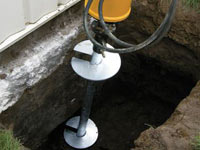 Installing a helical pier system in the earth around a foundation in Elk Grove