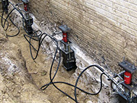 Using foundation push piers to lift a foundation during a repair in Napa.
